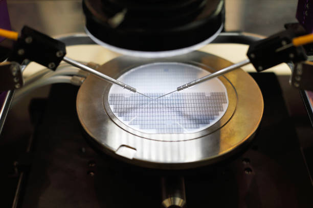 semiconductor silicon wafer undergoing probe testing Semiconductor silicon wafer undergoing probe testing. Selective focus. semiconductor stock pictures, royalty-free photos & images