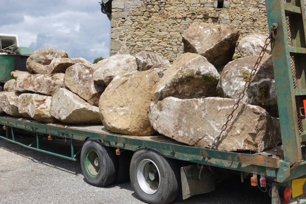Semi-trailer truck  Transporting large rocks by road stock photo