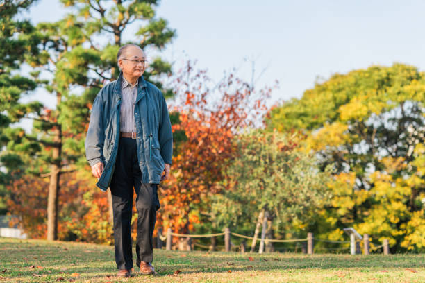 Senior adult man enjoying taking a walk in nature stock photo