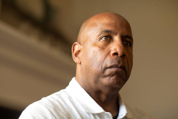 Senior African American man looking not smiling and looking depressed. stock photo