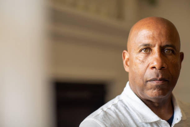 Senior African American man looking not smiling and looking depressed. Older African American man looking not smiling. sad old black man stock pictures, royalty-free photos & images