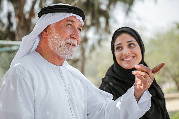 Senior arab man and young woman stock photo