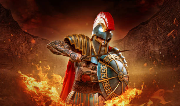 A senior bearded Warrior Gladiator holding a fiery weapon stock photo