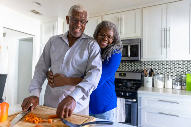 Senior Black Couple Making Dinner in the Kitchen stock photo