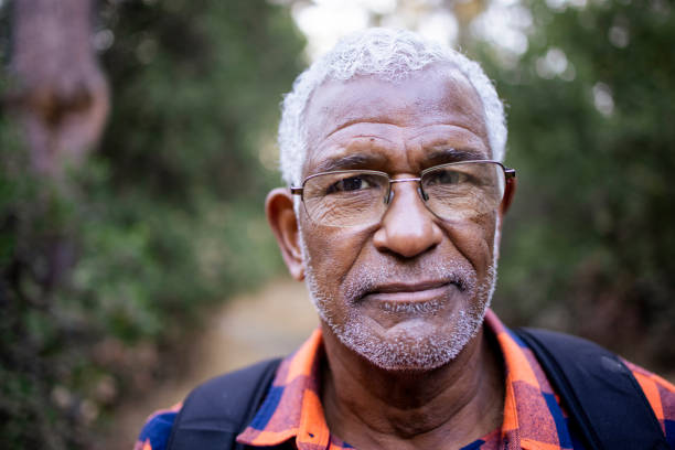 Senior Black Man Hiking in Nature A senior black man with white hair hiking outdoors. worried man funny stock pictures, royalty-free photos & images