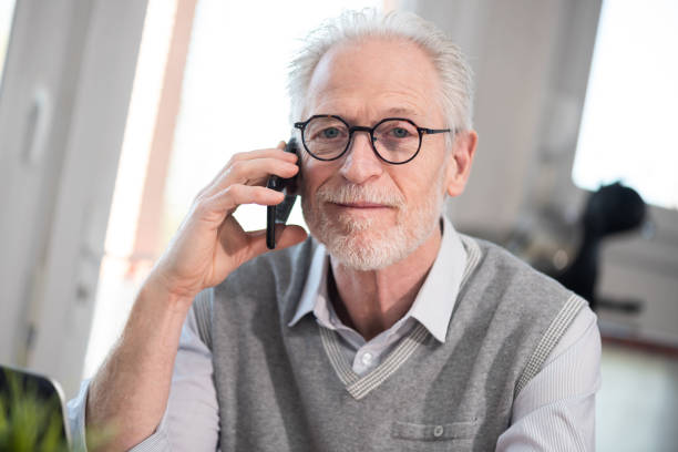 Senior businessman talking on mobile phone stock photo