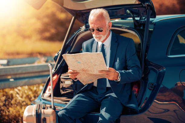 Senior businessman traveling on vacation Senior businessman traveling on vacation ,having little break. broken suitcase stock pictures, royalty-free photos & images