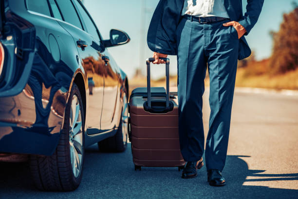 Senior businessman traveling to work in car Senior businessman traveling to work wit car,having little break. broken suitcase stock pictures, royalty-free photos & images