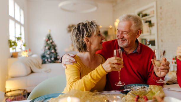 Senior couple celebrating Christmas Photo of senior couple on Christmas day, having lunch new year's day stock pictures, royalty-free photos & images