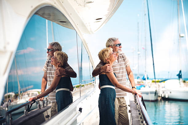 Senior Couple Enjoying On Vacations Senior woman and senior man relaxing on the yacht. marina stock pictures, royalty-free photos & images