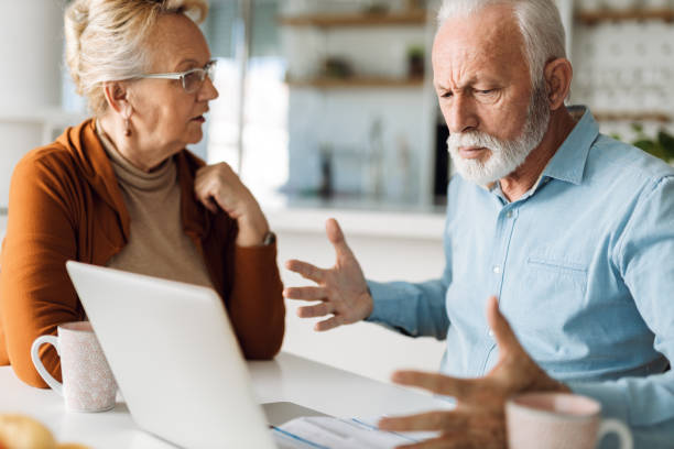 Senior couple  having problems with paying their bills stock photo