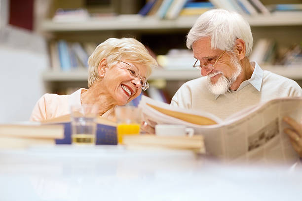 Senior couple in restaurant,coffee shop have fun and reading stock photo