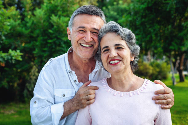 Senior couple smiling at the park stock photo