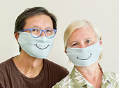 istock COVID-19 Senior Couple with Homemade Face Mask for Social Distancing 1217468788