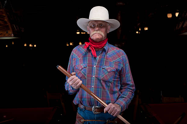Senior Cowboy Holding Pool Cue stock photo