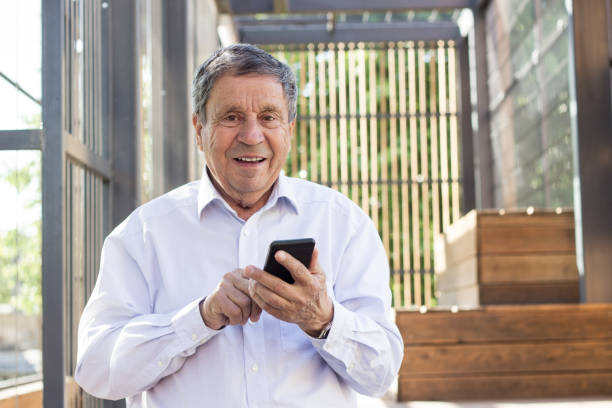 Senior man and his smartphone stock photo