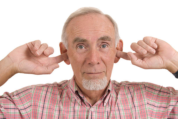 Senior man blocking ears  Fingers in Ears stock pictures, royalty-free photos & images