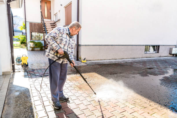 Senior Man Cleaning the Back Yard with High Pressure Washer Senior Man Cleaning the Back Yard with High Pressure Washer Cleaning pavement stock pictures, royalty-free photos & images