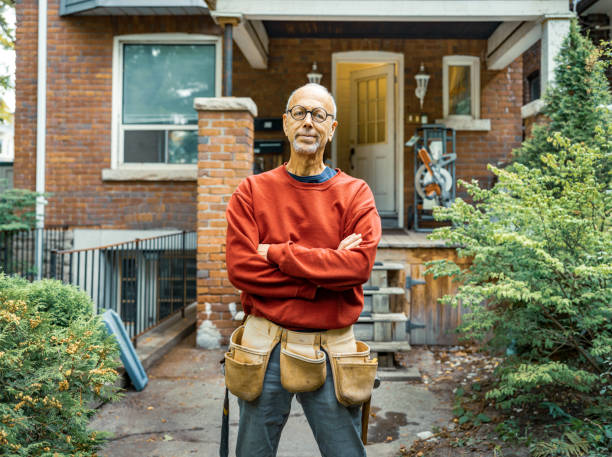 Senior man doing carpentry outdoors stock photo