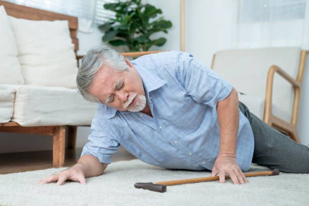 Senior man fell to the ground, Elderly Asian man with chest pain from a heart attack. stock photo