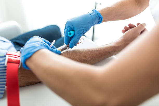 Senior man having a blood test done by a nurse Senior man having a blood test done by a nurse blood testing stock pictures, royalty-free photos & images
