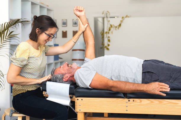 Senior man having chiropractic adjustment. stock photo