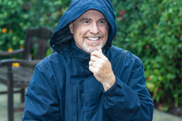 Senior man in the rain stock photo