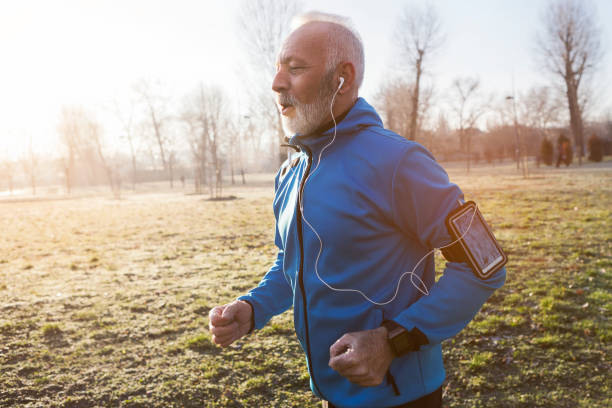 Senior man jogging in the morning Senior man jogging in city 60 69 years photos stock pictures, royalty-free photos & images
