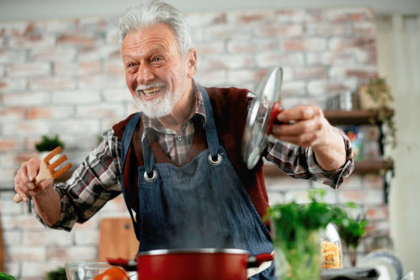 Old Man Cooking Alone Stock Photos, Pictures & Royalty-Free Images - iStock