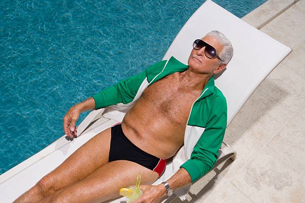 senior man relaxing by pool - retirement overview bildbanksfoton och bilder