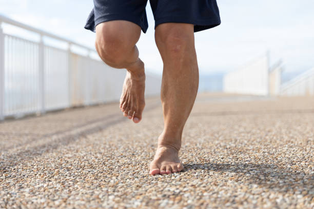 Senior man running barefoot stock photo