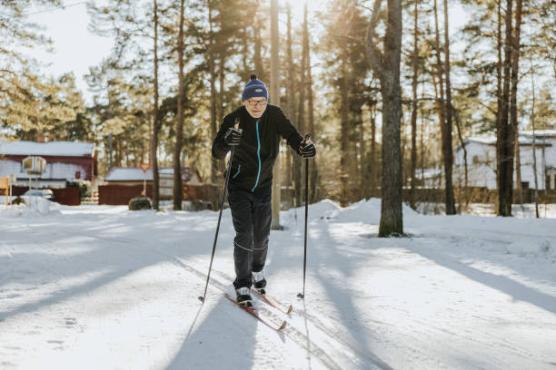 Senior man skiing in nature stock photo