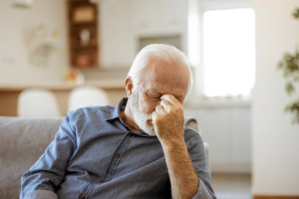 Senior Man Suffering From Headache at Home stock photo