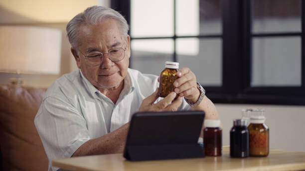 Senior man talking with a doctor online using digital tablet stock photo