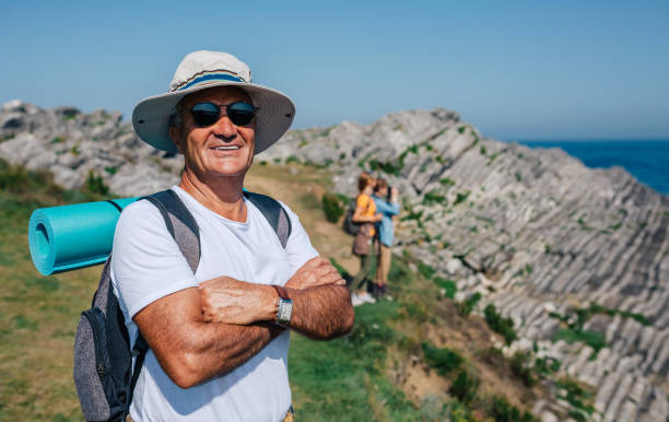 Senior man trekking looking at camera stock photo