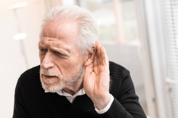 Senior man with hearing problems stock photo