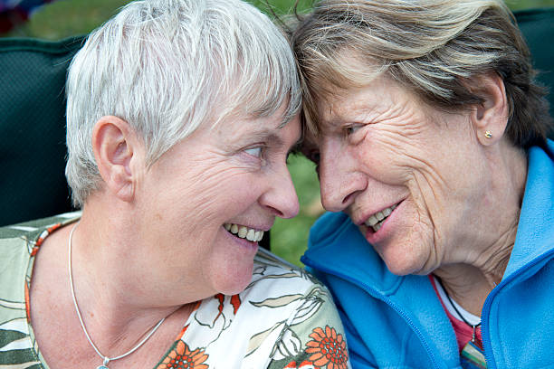 Senior Married Female Couple Laughing Together in Love stock photo