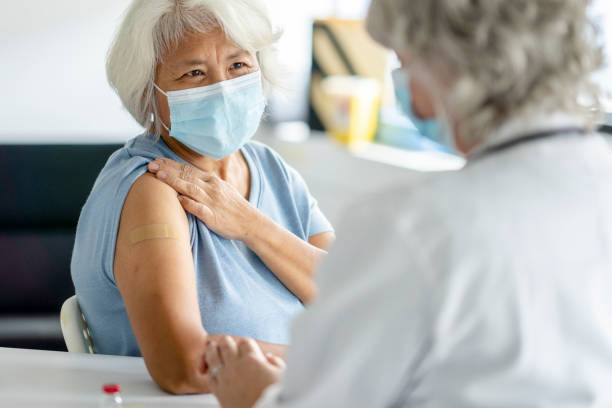 Senior Patient Successfully Receiving Her Vaccination stock photo