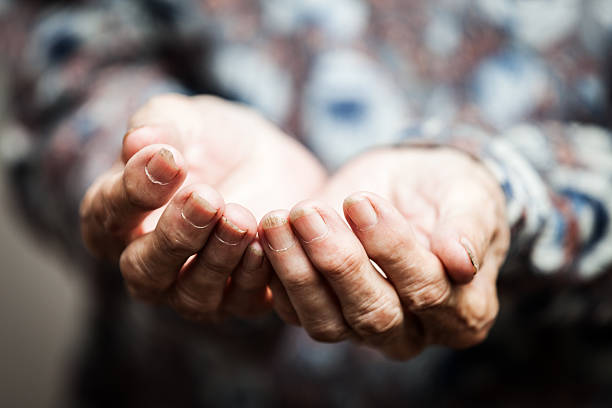 Senior person hands begging for food or help stock photo