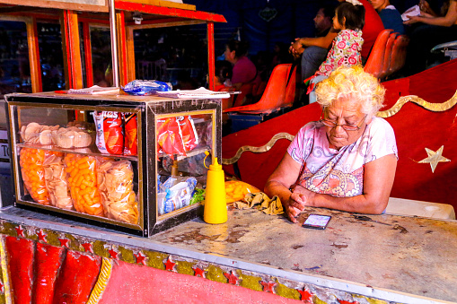 senior-person-sells-popcorn-and-candies-in-a-circus-in-northern-picture-id1222365381