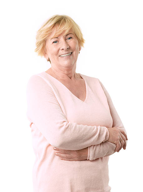 A senior smiling woman in a pink top stock photo