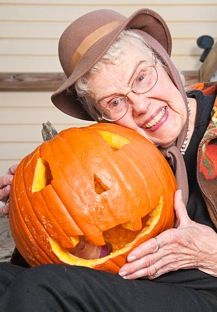 Senior woman and dear old jack o lantern stock photo