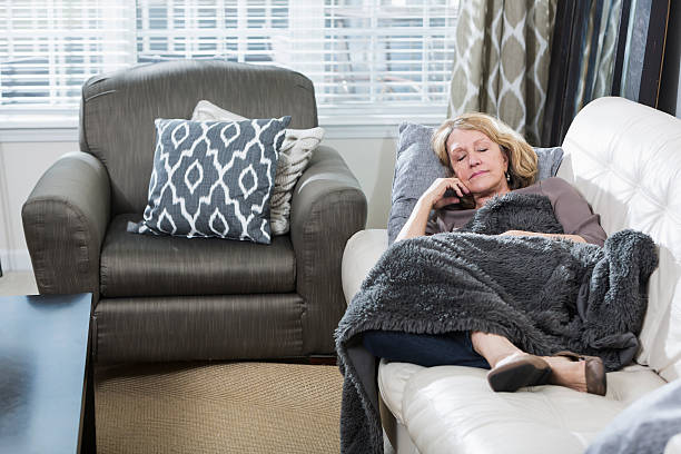 senior woman asleep on the couch - nap middle age woman bildbanksfoton och bilder
