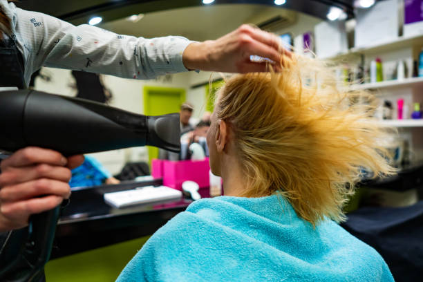 Senior woman having hair blow dried by hairstylist Senior woman having hair blow dried by hairstylist dry conditioner stock pictures, royalty-free photos & images