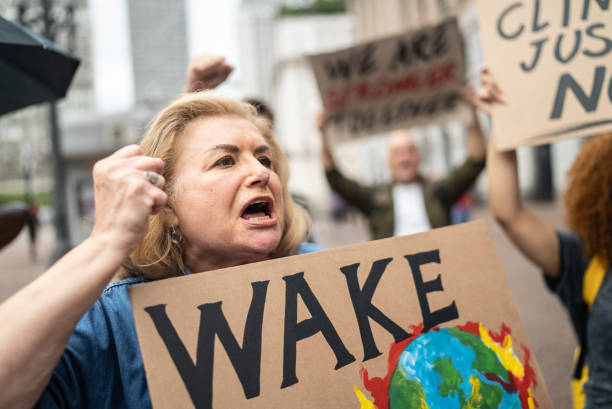 Senior woman holding a sign during a demonstration in the street