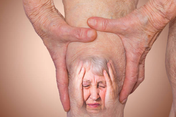 Senior woman holding the knee with pain Senior woman holding the knee with pain. Collage. Concept of abstract pain and despair. The elderly pensioner and her problems. Old age and illnesses. 86-year-old Caucasian model. healthcare concepts joint pain stock pictures, royalty-free photos & images