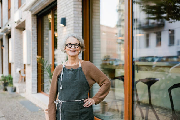 Senior woman in front of a coffee shop. stock photo