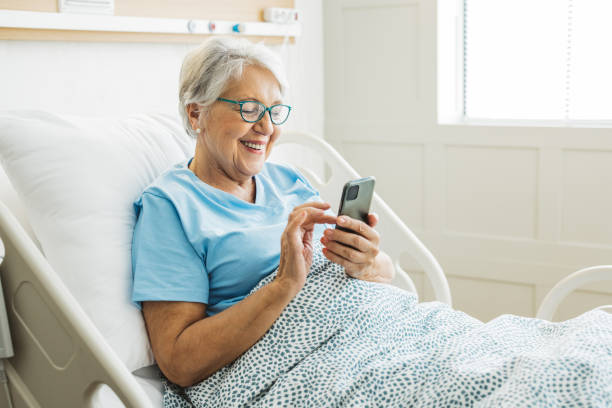 Senior woman in hospital bed stock photo
