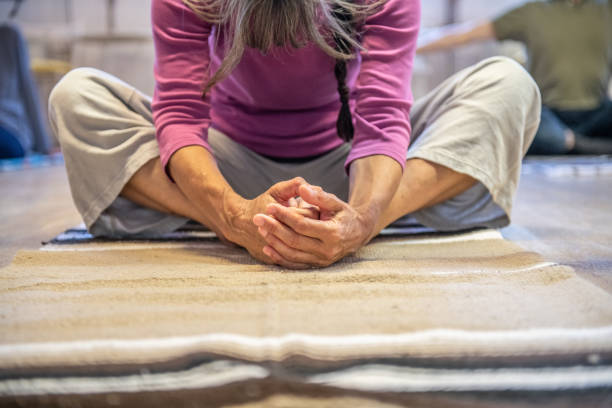 Senior Woman relaxing on the floor hands and legs close up stock photo