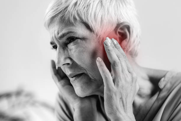 Senior Woman Suffering From Tinnitus stock photo